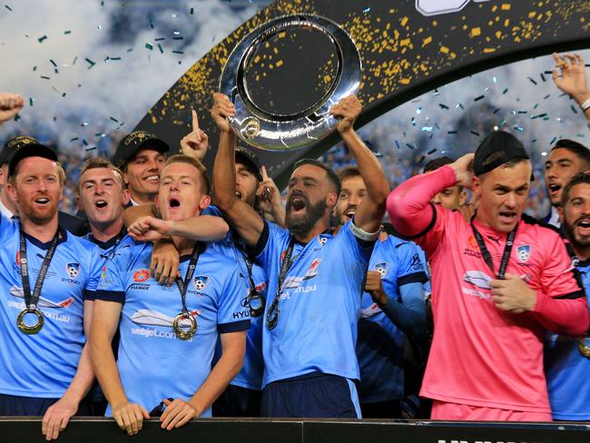 Alex Brosque raises the trophy after winning the 2017 A League Grand Final. Picture: Mark Evans