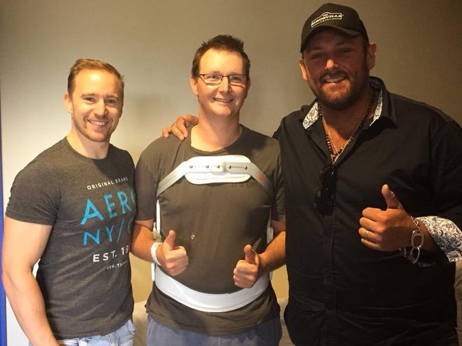 Wolfe Brothers band members Brodie Rainbird, left, and Tom Wolfe, right, with injured firefighter James Lusted. Picture: SUPPLIED