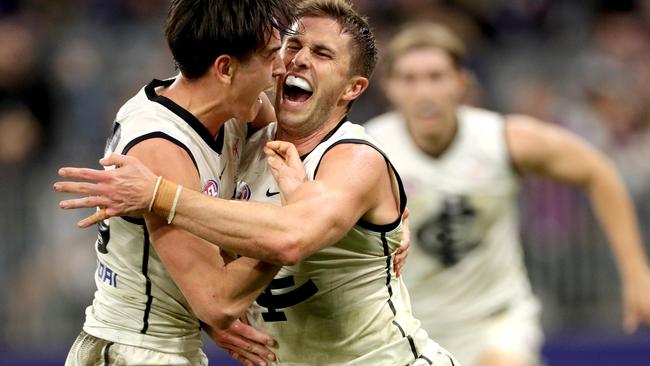 Marc Murphy (right) celebrates kicking the matchwinner against Fremantle last year with Zach Fisher.