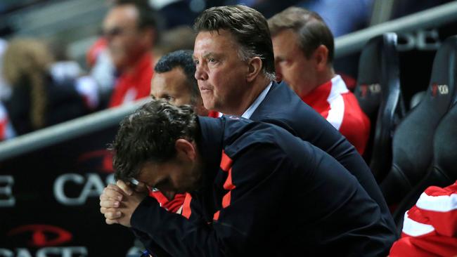 Manchester United Manager Louis van Gaal, centre rear, shows his dejection after their defeat by MK Dons in their League Cup Second Round match at Stadium:mk, Milton Keynes, England, Tuesday Aug. 26, 2014. MK Dons defeated Manchester United 4-0. (AP Photo/PA, Nick Potts) UNITED KINGDOM OUT NO SALES NO ARCHIVE