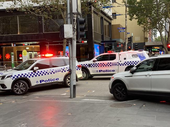 Police swooped on the corner of Collins and Elizabeth streets after a woman was attacked. Picture: Brandon Demura