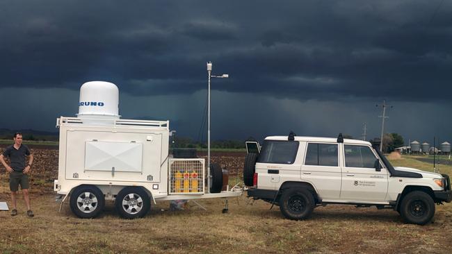 Radar meteorologist Dr Joshua Soderholm with the portable dual polarised x-band radar (UQ-XPOL) that is used to study severe weather, including thunderstorms and bushfires.