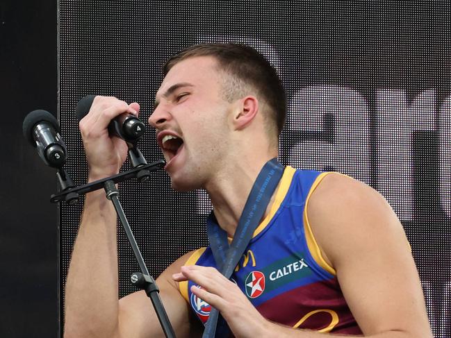 Darcy Wilmot grabs the microphone after receiving his premiership medal on the dais. Picture Lachie Millard