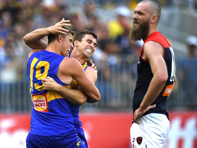 Nathan Vardy (left) and Jamie Cripps (centre) of the Eagles reacts after Cripps kicked a goal as Max Gawn of the Demons looks on during the Second Preliminary Final between the West Coast Eagles and the Melbourne Demons at Optus Stadium in Perth, Saturday, September 22, 2018. (AAP Image/Julian Smith) NO ARCHIVING, EDITORIAL USE ONLY