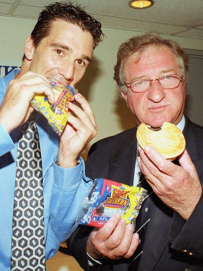 Stephen Silvagni and John Elliott sampling a meat pie.