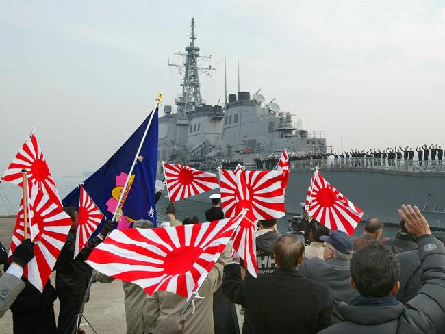 Wellwishers wave rising sun flags as they see off the crew aboard the Aegis-equipped destroyer Kirishima of Japan's Maritime Self Defense Force at Yokosuka base, south of Tokyo.