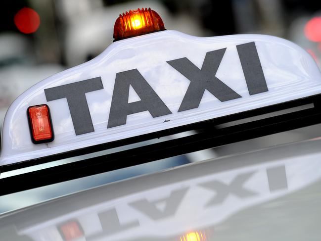 A taxi seen passing through the central business district in Sydney, Friday, Nov. 6, 2015. Four men allegedly involved in the use of taxis to provide a cocaine-delivery service across Sydney have been arrested during a police operation this morning. (AAP Image/Joel Carrett) NO ARCHIVING