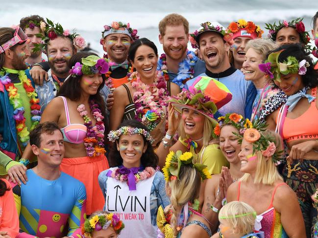 Britain's Prince Harry and his wife Meghan, the Duchess of Sussex pose during a "Fluoro Friday" session run by OneWave. Picture: AFP