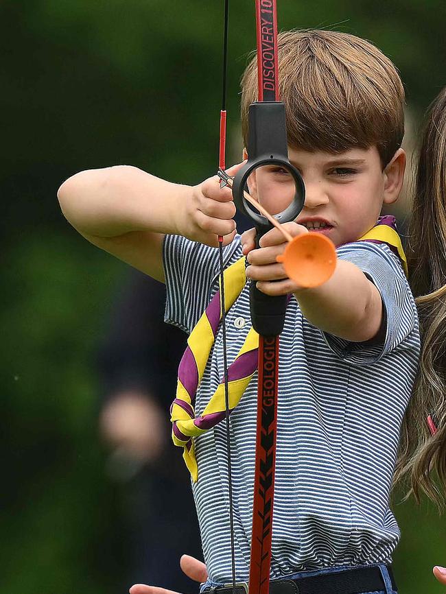 Prince Louis of Wales tries his hand at archery while taking part in the Big Help Out. Picture: AFP.