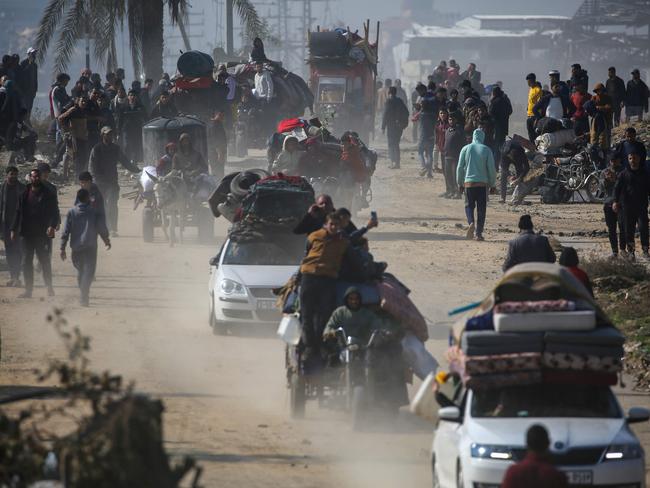 Some pulled carts weighed down with mattresses and other essentials. Picture: AFP