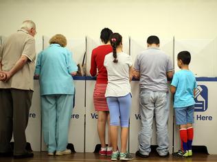 People voting in the state election at Currins Hill Public School. Picture: Jonathan Ng