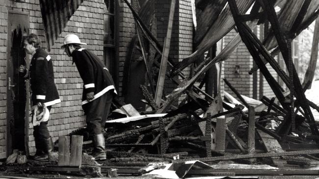 Firemen inspect the smouldering ruins of The Swagman restaurant in Ferntree Gully after it was destroyed by fire in 1991.