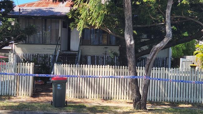 Police tape surrounds the perimeter of the Elphinstone Street house on Thursday, December 29, 2022.