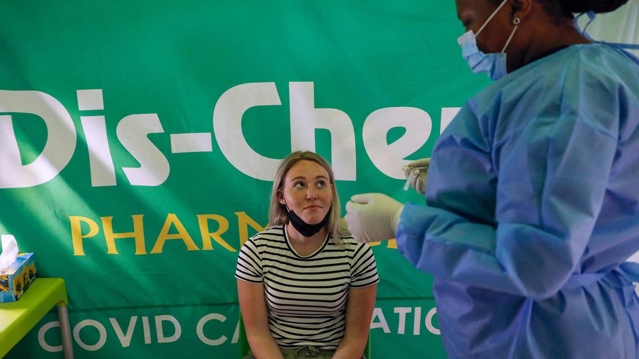 A healthcare worker prepares to conduct a polymerase chain reaction (PCR) Covid-19 test on a traveller at OR Tambo International Airport in Johannesburg on November 27, 2021, after several countries banned flights from South Africa. Picture: Phill Magakoe / AFP