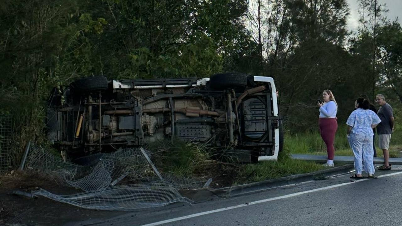 A white four-wheel drive flipped onto its side near Maroochydore Noosa Rd and David Low Way, on the border of Pacific Paradise and Maroochydore.