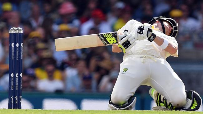 Australia's batsman Steve Smith bends to avoid a short-pitched ball off England's Chris Woakes on the third day of the first cricket Ashes Test between England and Australia in Brisbane on November 25, 2017. / AFP PHOTO / SAEED KHAN / -- IMAGE RESTRICTED TO EDITORIAL USE — STRICTLY NO COMMERCIAL USE —