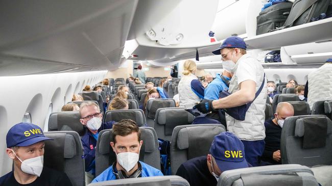 Norwegian, Swedish and Danish athletes aboard a charter flight to Beijing.