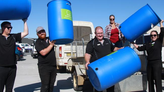 WILDLIFE SAVER: Lismore Toyota staff Michael Vidler, Jordan Collings, Gareth Collings and (far right) Lismore Toyota principal and project supporter Sarah Smith help landowner Hayley Burgess load her trailer with 220Lt TREE TROFFÂ® arboreal water drinkers which are being distributed free of charge for installation on their properties. Photo: Alison Paterson