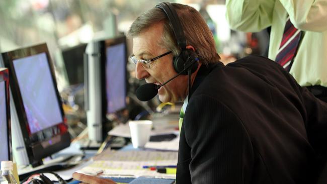 Dennis Cometti broadcasting during Collingwood vs Fremantle Dockers football match at MCG in 2004.