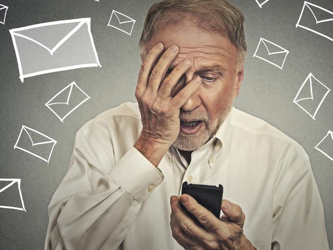 Upset stressed man holding cellphone disgusted shocked with message he received isolated on gray background. Funny looking human face expression emotion feeling reaction life perception body language