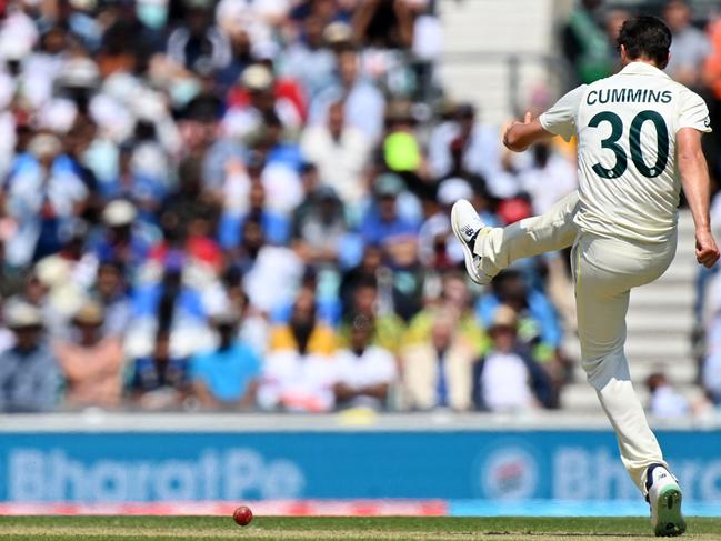 Pat Cummins kicks the ball. Picture: Glyn Kirk/AFP