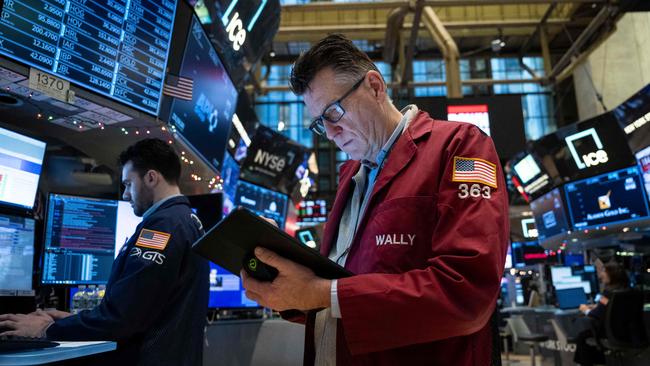 Traders work on the floor of the New York Stock Exchange (NYSE) during morning trading on January 3, 2024, in New York City. Wall Street stocks slumped to start Wednesday with all three major US indices in the red and key names such as Facebook parent Meta Platforms and Nvidia falling. (Photo by ANGELA WEISS / AFP)