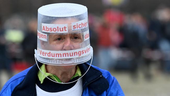 A participant wears a bucket as protection during a demonstration against the coronavirus COVID-19 restrictions in Munich, southern Germany. Picture: AFP