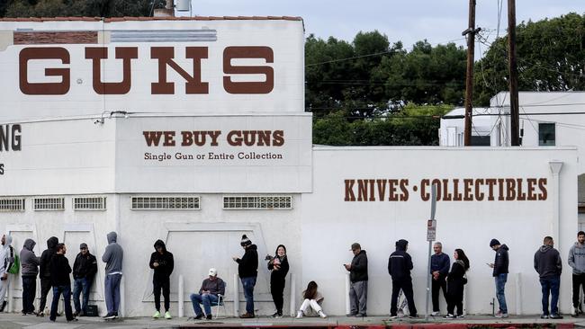 People wait in a line to enter a gun store as stores are seeing a run on weapons and ammunition. Picture: Ringo H.W. Chiu