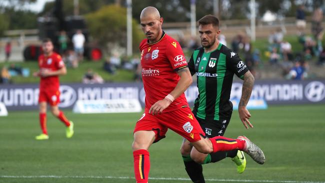 Adelaide United’s James Troisi returns to action after a quad injury. Troisi in action against Western United’s Josh Risdon at Whitten Oval in January. (AAP Image/George Salpigtidis)