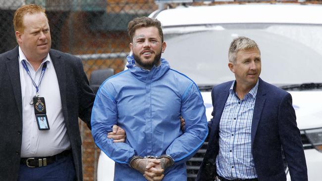 Ben Geppert being walked into the Southport Watchhouse after his arrest. Picture: Tertius Pickard.