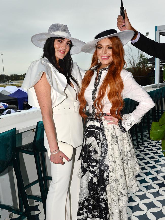 Lindsay Lohan was joined by sister Ali, and someone else to helpfully hold up an umbrella. Picture: Nicki Connolly