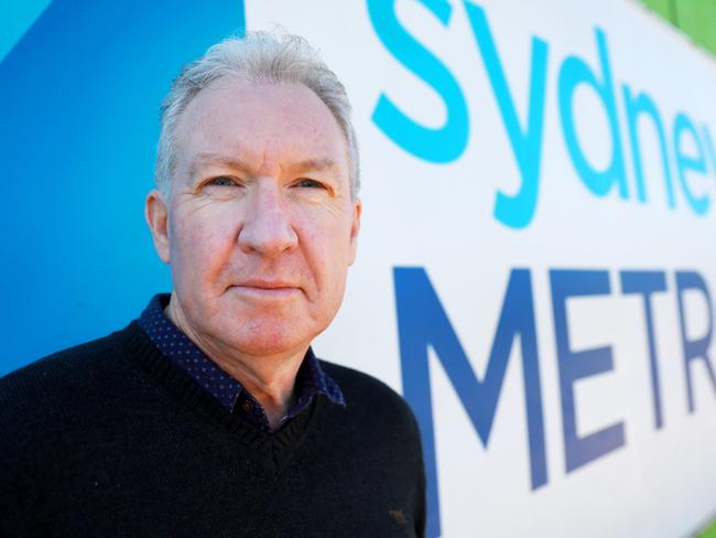 Peter Townend poses for photographs in front of the construction works at Cherrybrook Station. Cherrybrook, Saturday, July 21st 2018. Peter Townend wants answers over the Cherrybrook Station Precinct. Residents have been waiting for a decision to be handed down for the past 5 years. (AAP Image / Angelo Velardo)