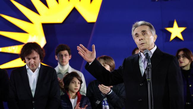 Georgian oligarch and founder of the ruling Georgian Dream party Bidzina Ivanishvili gives a speech as Georgian Prime Minister Irakli Kobakhidze stands behind. Picture: AFP