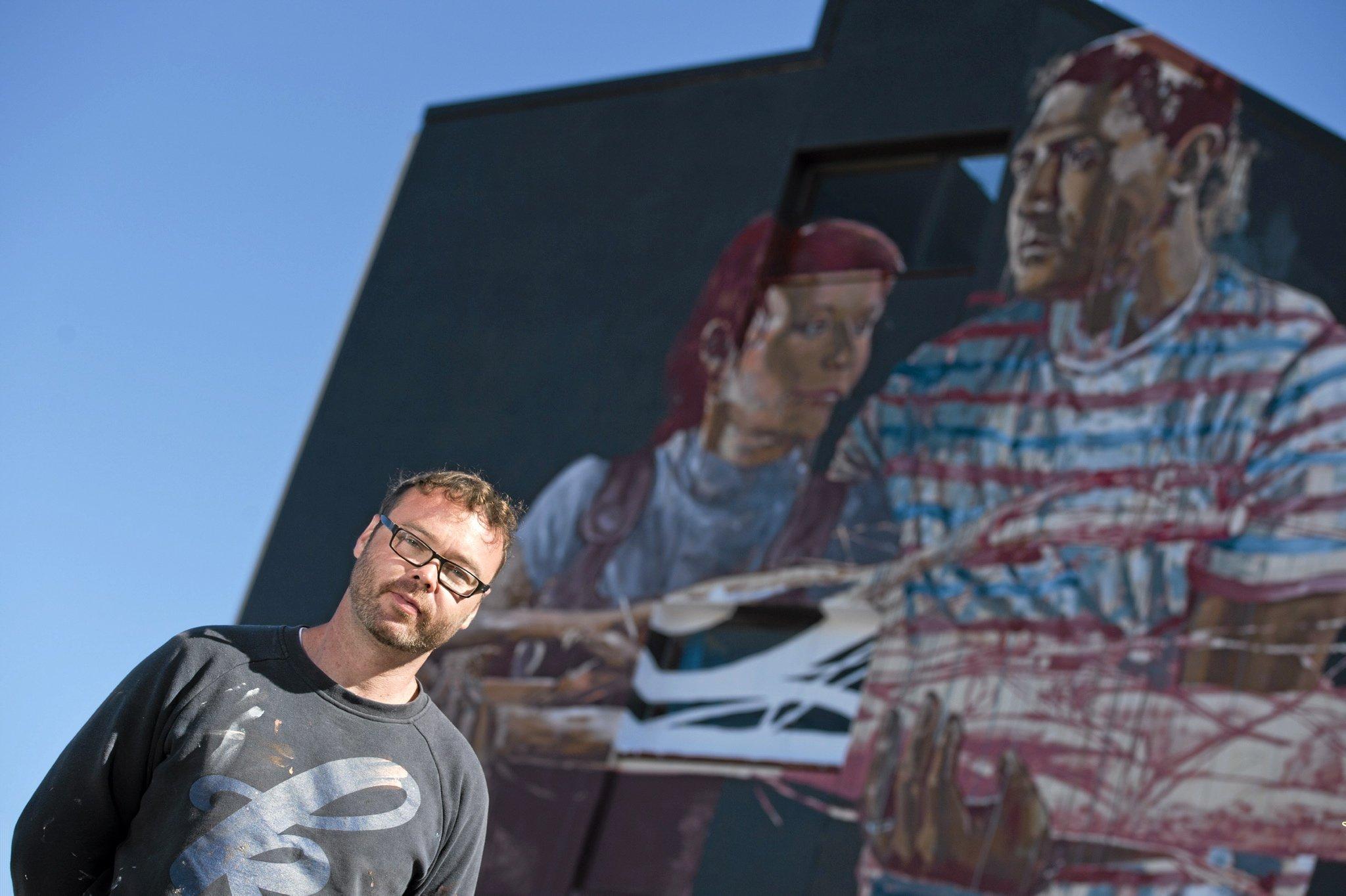 Fintan Magee paints on the SES building wall in Hume St car park for First Coat, Monday, May 30, 2016. Picture: Kevin Farmer