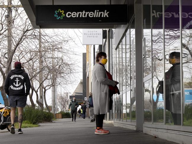 A woman waits outside Centrelink in South Melbourne.