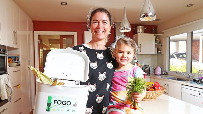 Jacinta Moloney with three year old daughter Sasha Sinclair inside their kitchen with their FOGO bin for food scraps. Picture: Zak Simmonds