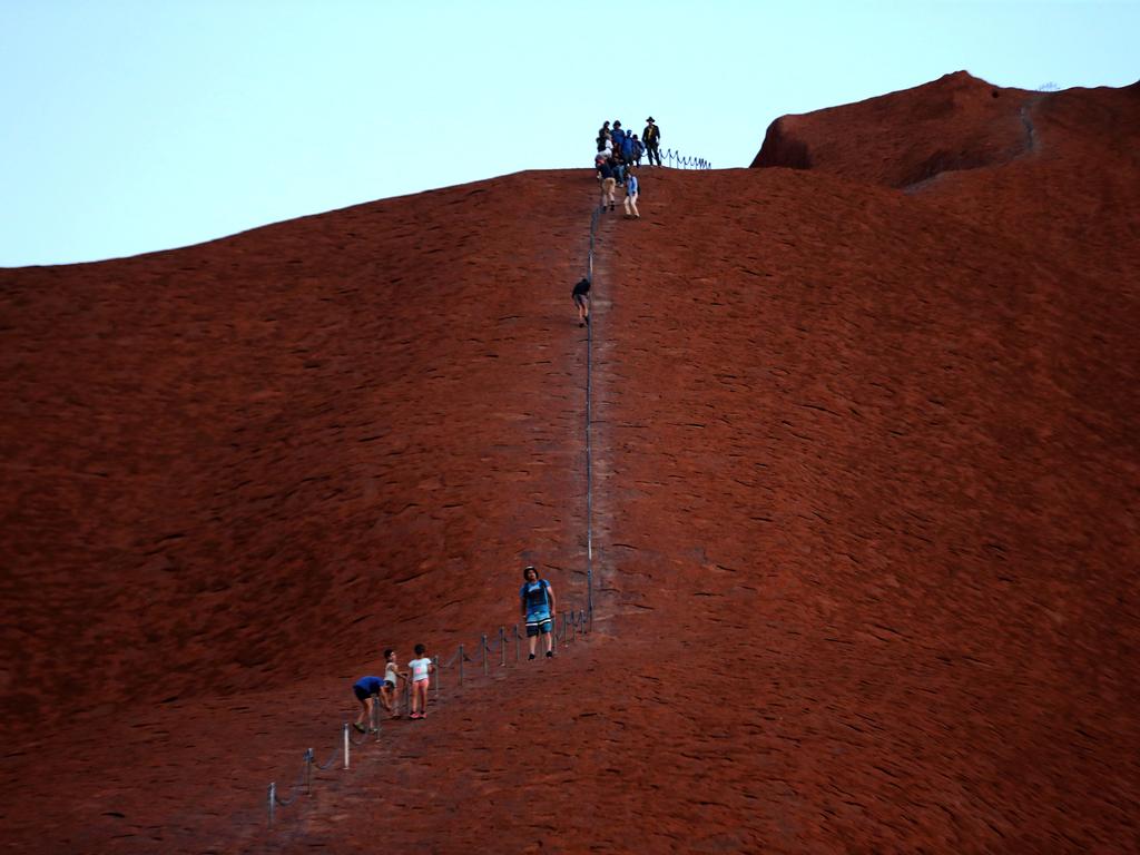 The last climbers descend Uluru on the last day of climbing. Picture: David Geraghty/The Australian