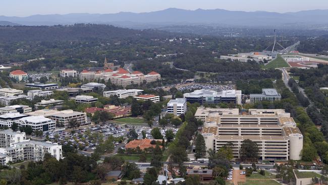 View of Canberra aerial, buildings and trees, Parliament House in background and Edmond barton building in foreground.