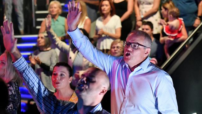 Prime Minister Scott Morrison and wife Jenny sing during an Easter Sunday service at his Horizon Church at Sutherland in Sydney, Sunday, April 21, 2019. Picture: Mick Tsikas