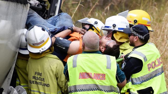 Personnel from Queensland Fire and Emergency Service, Rural Fire, Police and Ambulance work seamlessly to free a 27-year-old Ingham man from the wreckage of his Volvo truck on the Bruce Highway at Yuruga, 20km south of Ingham on September 5 last year. Picture: Cameron Bates