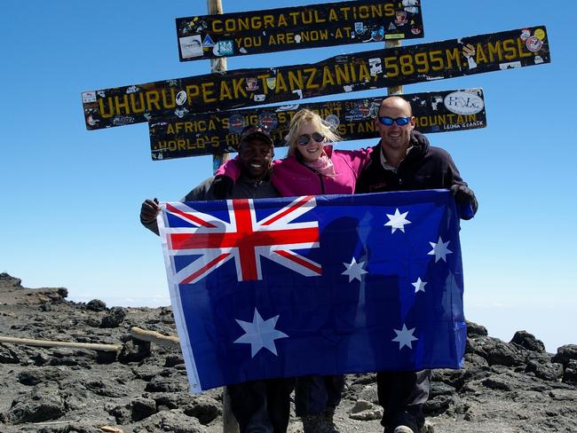 Alyssa Azar, her dad and their guide Godson on the summit of Mt Kilimanjaro.