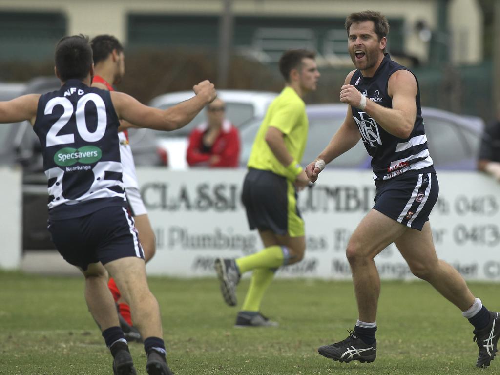 Southern Football League: Noarlunga v Flagstaff Hill. Noarlunga's Captain, Tom Caudle celebrates his snapped goal with team mate (20) Reece Martell. 13 April 2019. (AAP Image/Dean Martin)