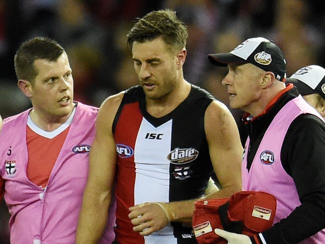 Sam Fisher of the Saints is taken off injured as Lance Franklin of the Swans scores a goal in the third quarter during the Round 21 AFL match between the St Kilda Saints and the Sydney Swans at Etihad Stadium in Melbourne, Saturday, Aug. 13, 2016. (AAP Image/Tracey Nearmy) NO ARCHIVING, EDITORIAL USE ONLY
