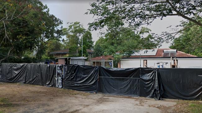 The Waterford West house from hell which has plastic sheets on the fence to hide the mess inside.