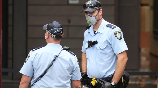 Sydney Police help to book in travellers over the weekend. Picture: John Grainger