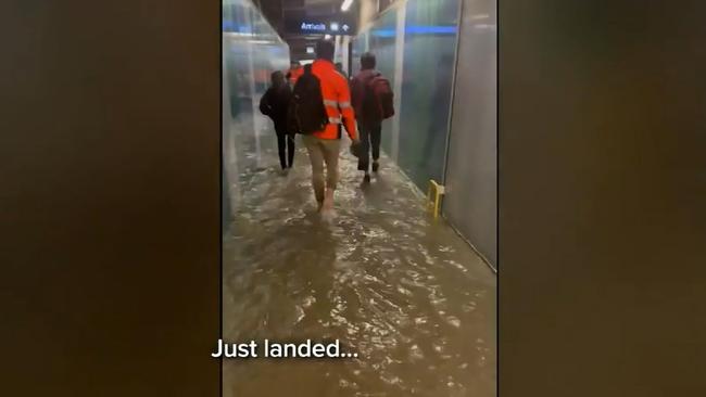 People were forced to wade through ankle-deep water at Perth airport. Picture: 9 NEWS