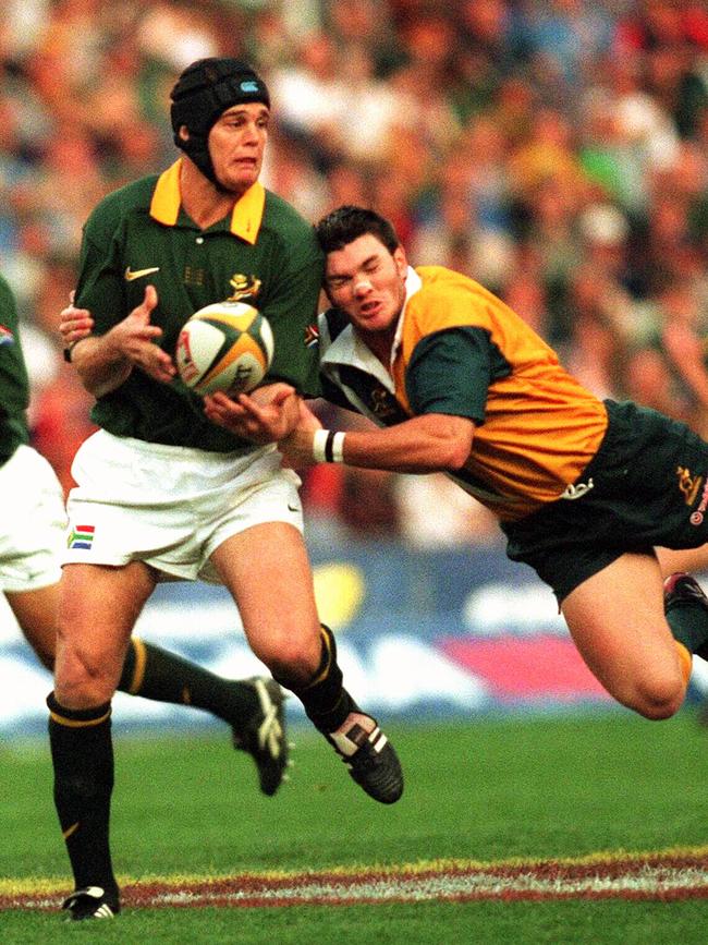 Dan Herbert hangs on to Rassie Erasmus.