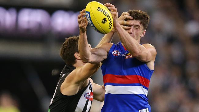 Collingwood's Brody Mihocek was reported for this late, high contact on Bulldog Tom Liberatore. Pic: Michael Klein.