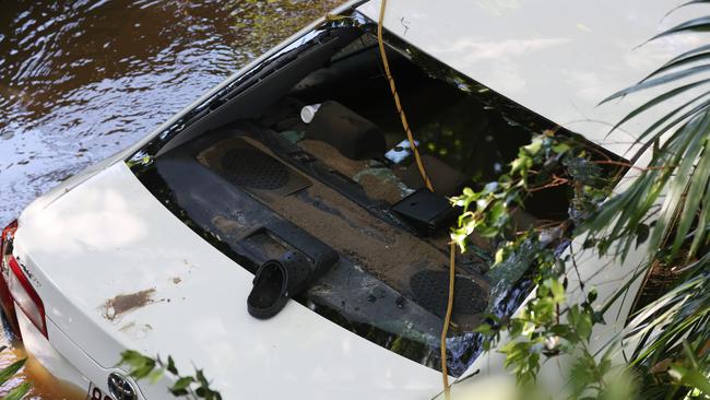 A 44-year-old woman is dead after her car was swept away in floodwaters in Aspley last night. Pics Tara Croser.