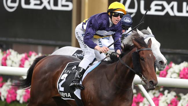 Jockey Damian Lane salutes on Aristia in the Kennedy Oaks at Flemington in November. Picture: AAP Image/David Crosling